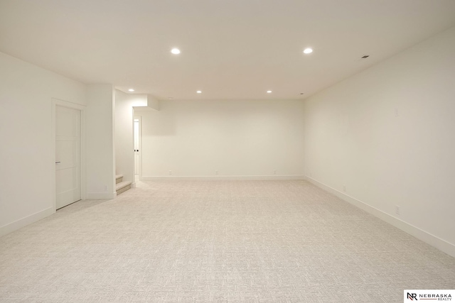 unfurnished room featuring light colored carpet