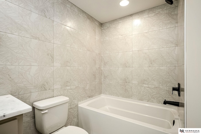 full bathroom with tile walls, toilet, vanity, and shower / washtub combination