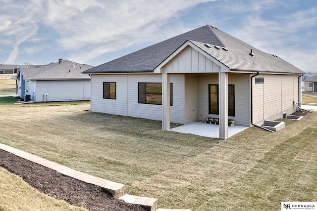 rear view of house featuring a lawn and a patio area