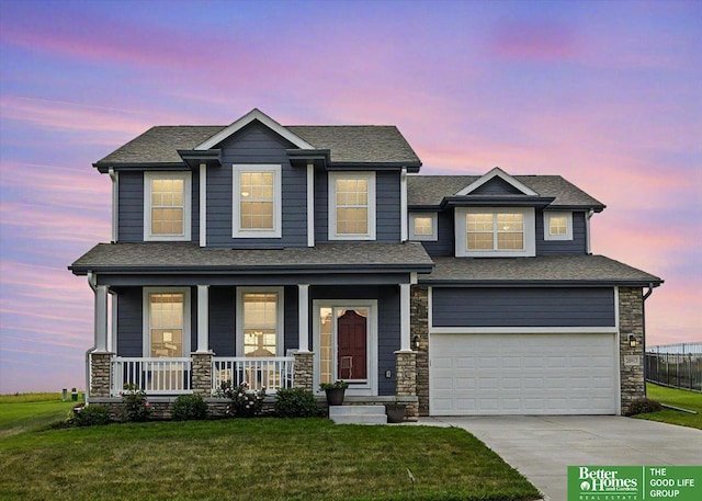 craftsman inspired home featuring covered porch, a yard, and a garage