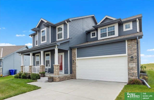 craftsman inspired home featuring covered porch and a garage