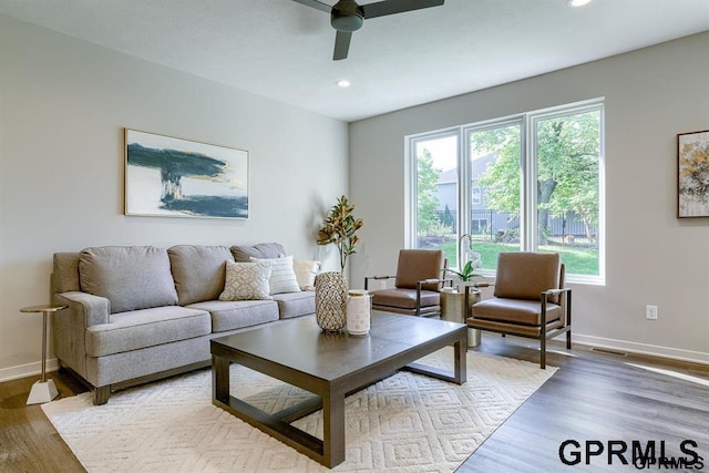 living room with hardwood / wood-style flooring and ceiling fan