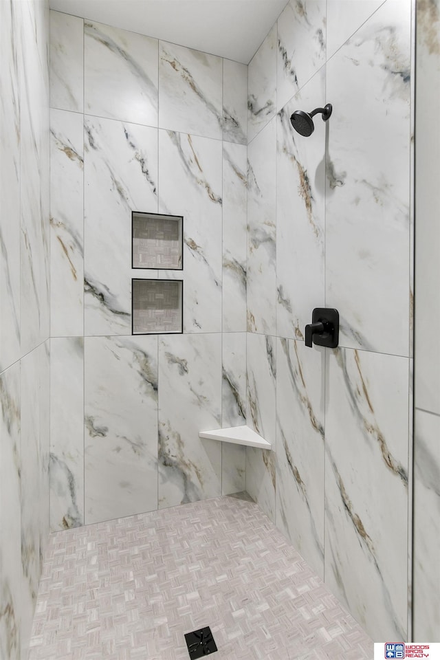 bathroom with tiled shower