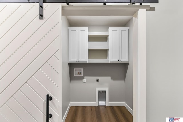 washroom with a barn door, washer hookup, dark hardwood / wood-style floors, and hookup for an electric dryer