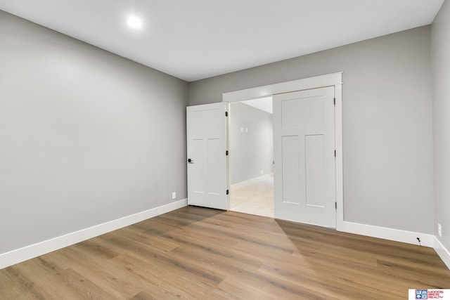 spare room with hardwood / wood-style floors