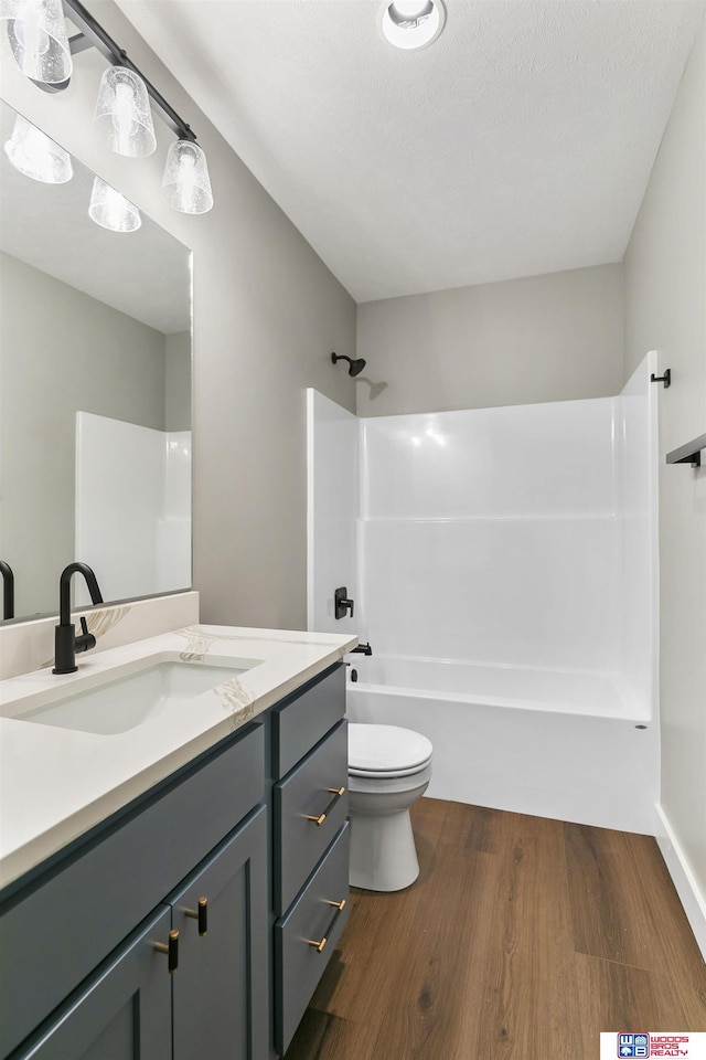 full bathroom featuring shower / bathtub combination, vanity, toilet, and wood-type flooring