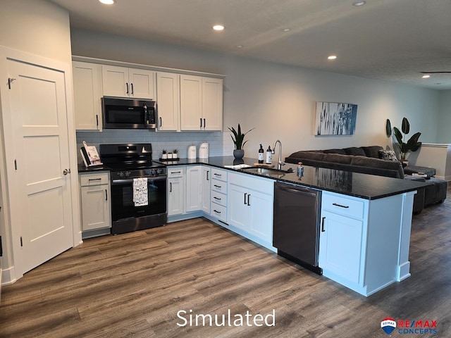 kitchen featuring white cabinets, appliances with stainless steel finishes, kitchen peninsula, and sink