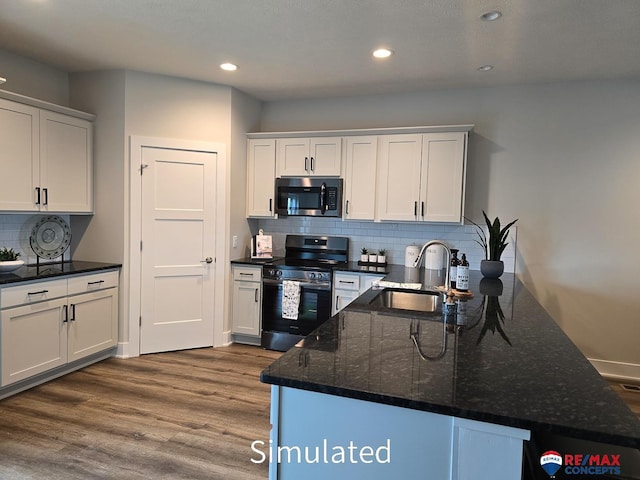 kitchen featuring dark stone countertops, sink, white cabinetry, and stainless steel appliances