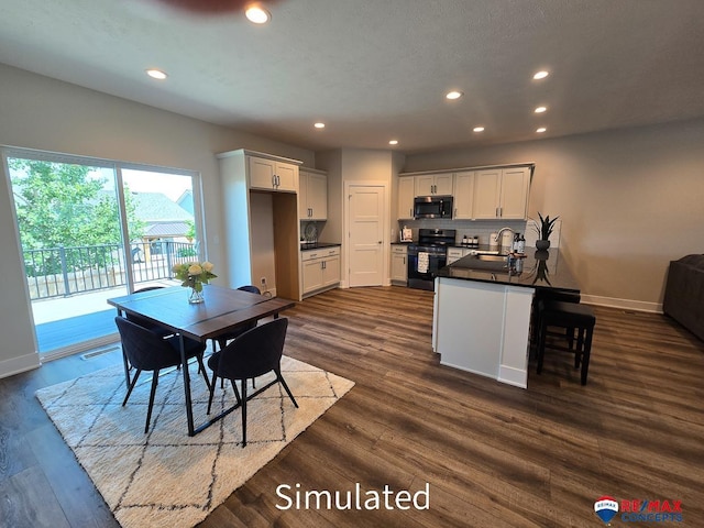 dining room featuring dark hardwood / wood-style flooring and sink