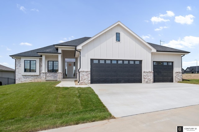 view of front of property with a front yard and a garage