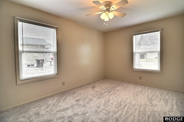 carpeted empty room featuring ceiling fan