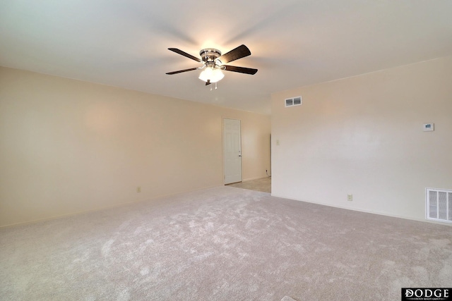 spare room featuring ceiling fan and light carpet