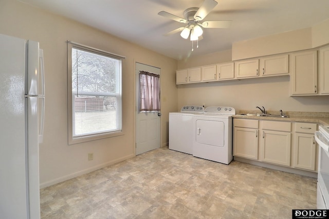 laundry area featuring washing machine and dryer, ceiling fan, and sink