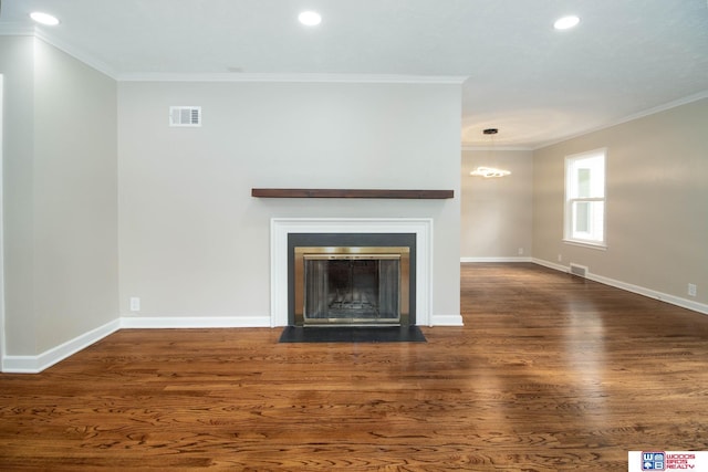 unfurnished living room with dark hardwood / wood-style floors, crown molding, and a notable chandelier