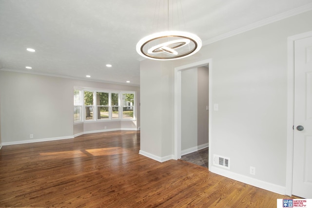 unfurnished room featuring dark hardwood / wood-style floors and crown molding