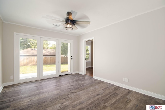 unfurnished room featuring dark hardwood / wood-style floors, ceiling fan, and crown molding