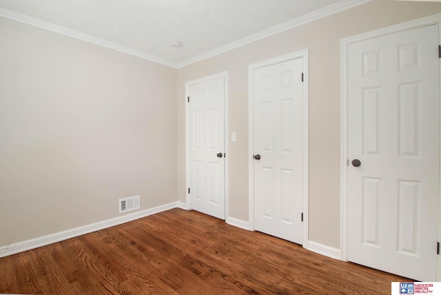 unfurnished bedroom featuring hardwood / wood-style floors and ornamental molding