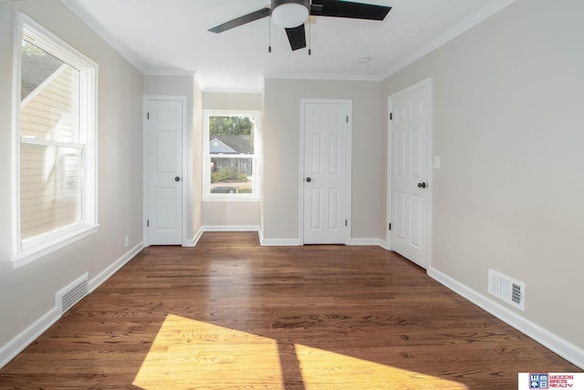 spare room with crown molding, ceiling fan, and dark wood-type flooring