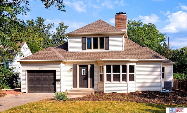 front facade featuring a garage and a front lawn