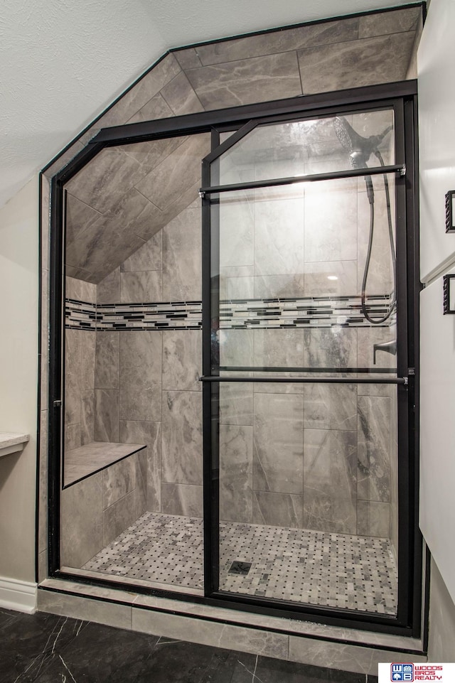 bathroom featuring a shower with shower door