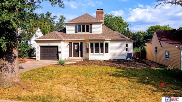 view of front of house with a front yard and a garage