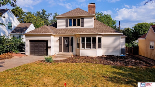 view of front of house with a garage and a front lawn