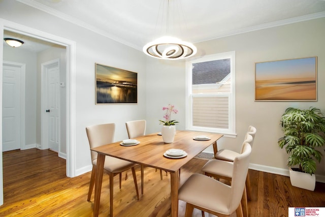 dining room with crown molding and hardwood / wood-style floors