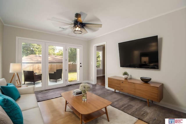 living room with hardwood / wood-style flooring, ceiling fan, and ornamental molding