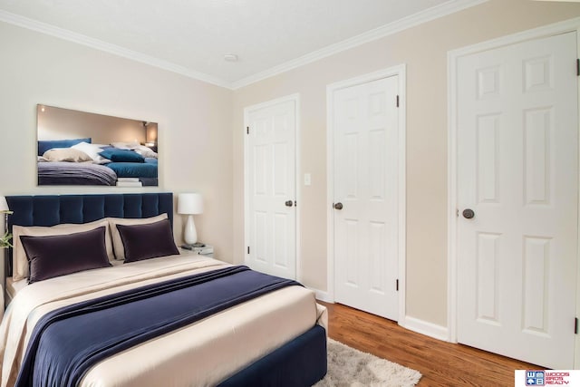 bedroom featuring hardwood / wood-style flooring and crown molding