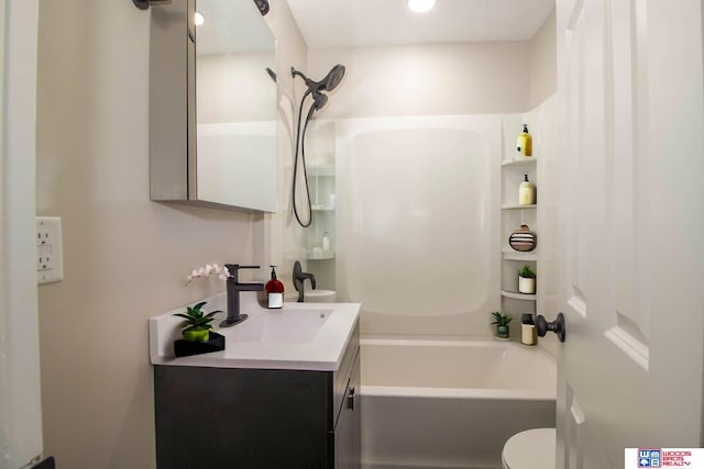 full bathroom with washtub / shower combination, vanity, and toilet