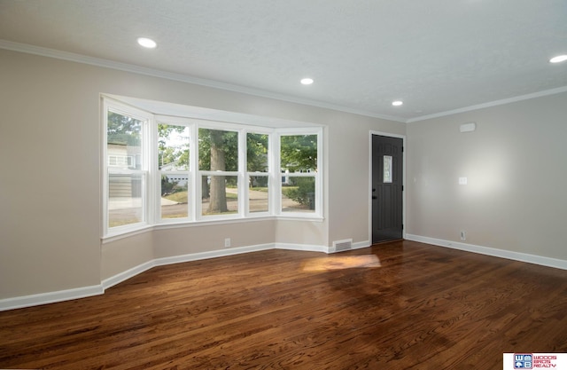 entrance foyer with dark hardwood / wood-style floors and ornamental molding