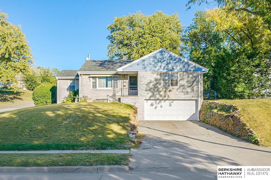 view of front facade with a front lawn and a garage