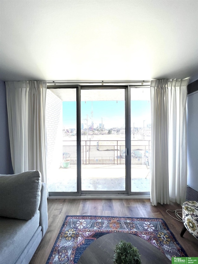 living room with hardwood / wood-style flooring and floor to ceiling windows