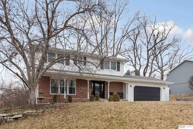 view of front of property with a garage and a front lawn