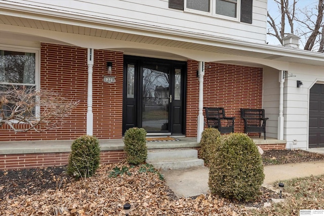 view of exterior entry featuring covered porch