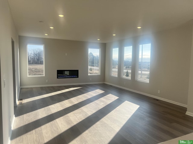 unfurnished living room with dark hardwood / wood-style flooring