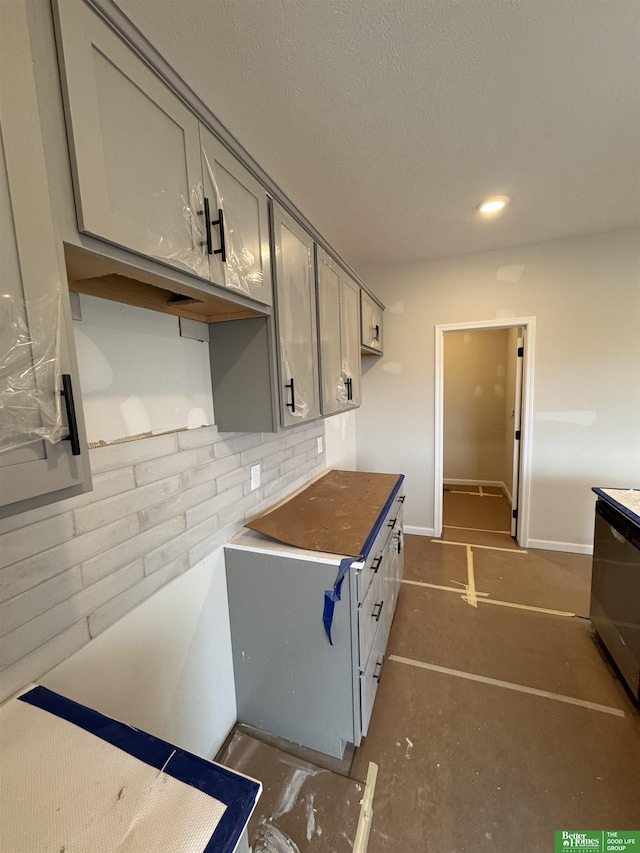 kitchen featuring backsplash and gray cabinets