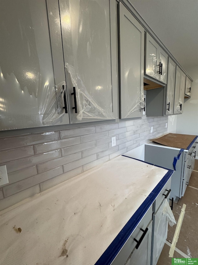 kitchen featuring gray cabinets and tasteful backsplash