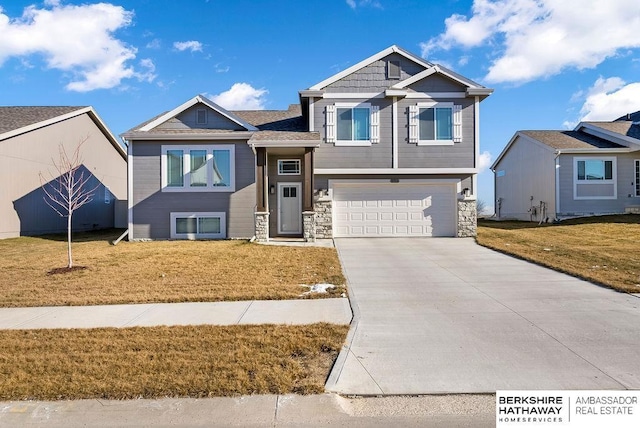 view of front of house with a garage and a front lawn