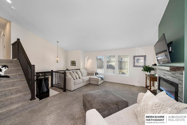 carpeted living room featuring a tiled fireplace and vaulted ceiling