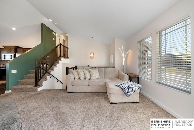 living room with carpet floors and vaulted ceiling