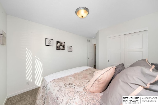 bedroom with light colored carpet and a closet