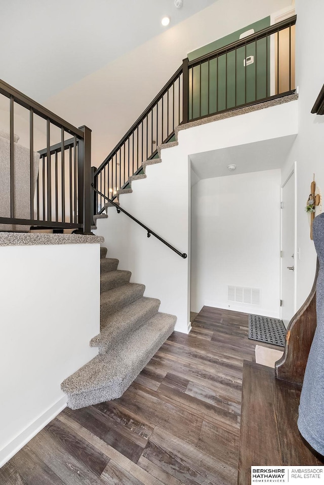 stairway with hardwood / wood-style floors