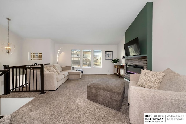 carpeted living room with a fireplace, vaulted ceiling, and an inviting chandelier