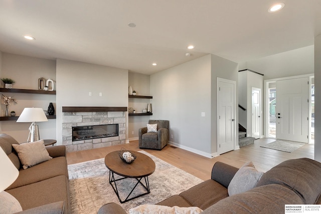 living room featuring light hardwood / wood-style flooring and a fireplace