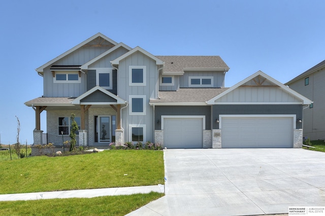 craftsman inspired home with a garage and a front lawn