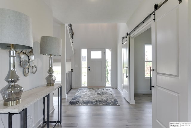 entryway with hardwood / wood-style floors and a barn door