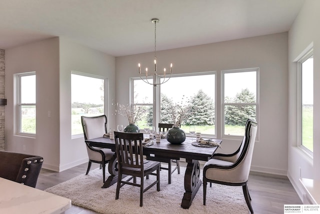 dining area with a chandelier and light wood-type flooring