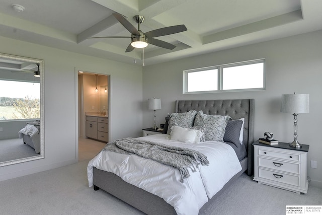 bedroom featuring ensuite bath, coffered ceiling, light colored carpet, ceiling fan, and beamed ceiling