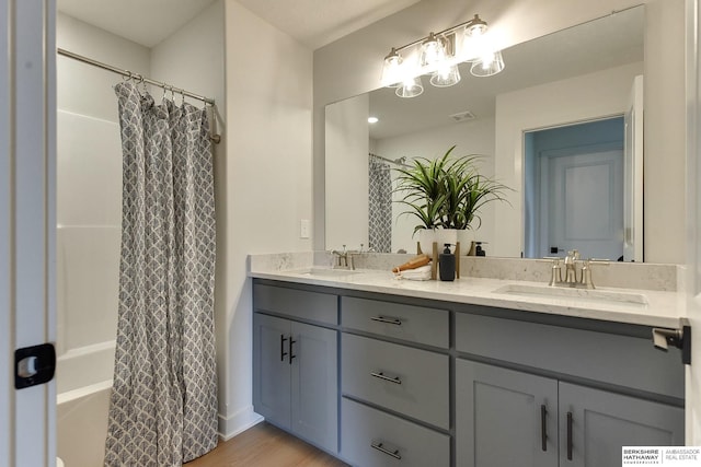 bathroom with shower / tub combo, vanity, and hardwood / wood-style flooring